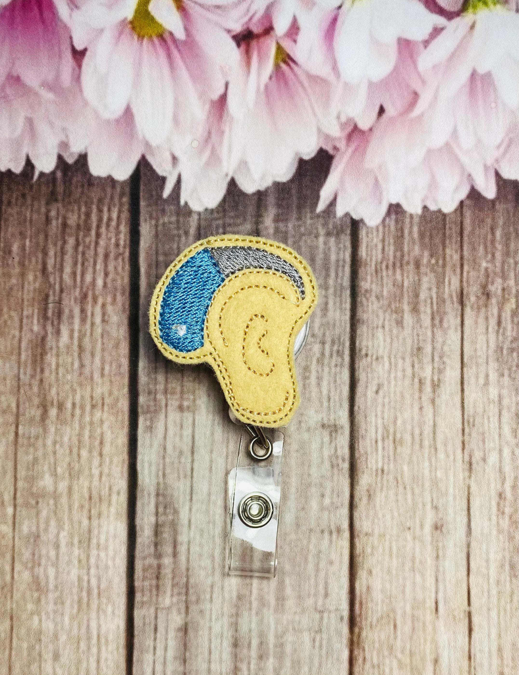 Hearing aid retractable badge reel