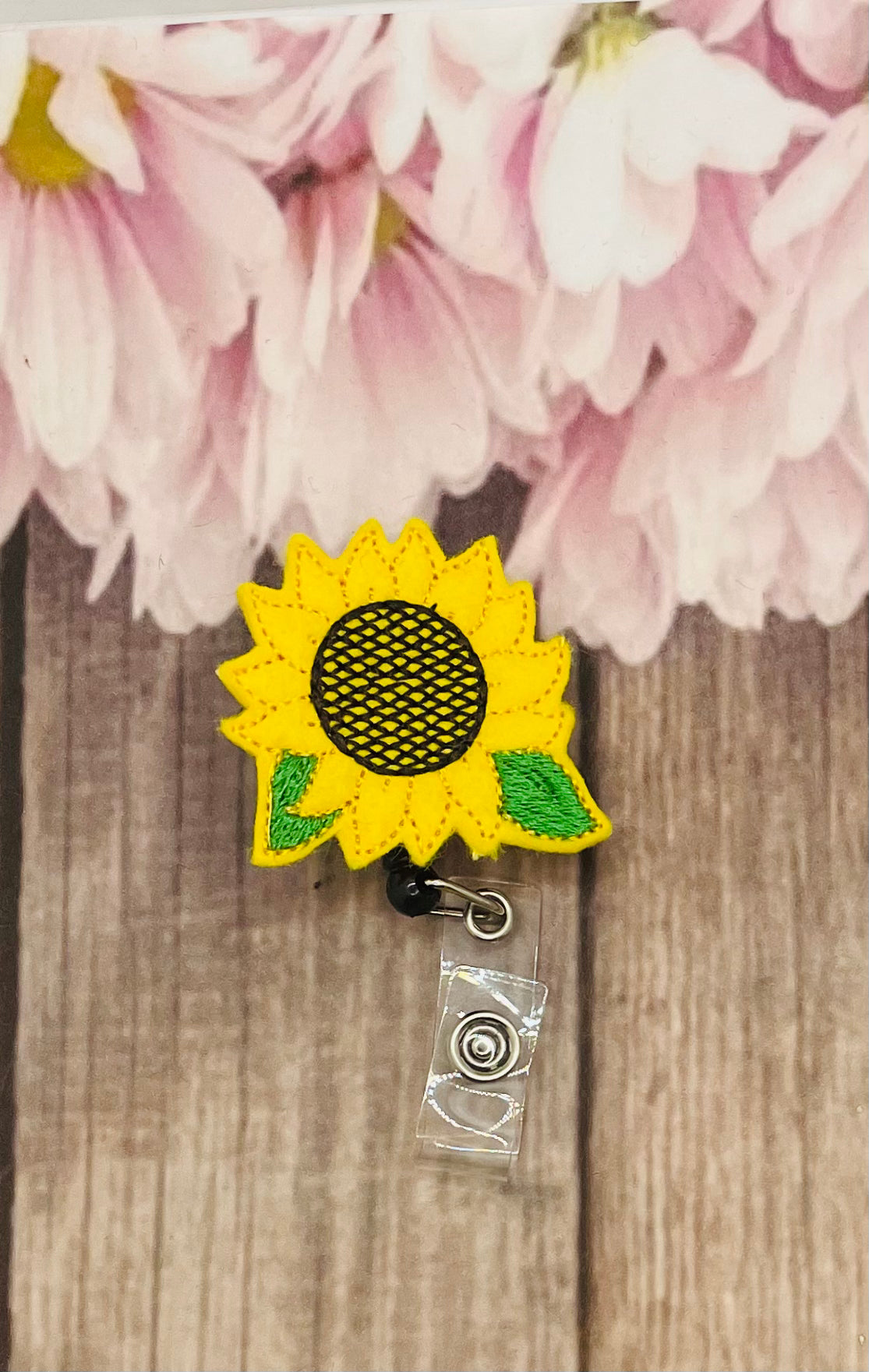 Smiling sunflower badge holder with retractable reel